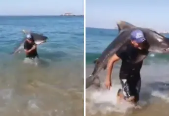 Hombre atrapa con sus propias manos a un tiburón Tigre en playa mexicana | VIDEO
